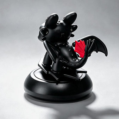 Black Toothless dragon ornament rear view with wings and red tail fin