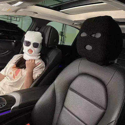 CARMOJ Black and white car seat headrest covers shown inside a car