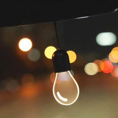 CARMOJ Glowing light bulb car charm showing warm white light