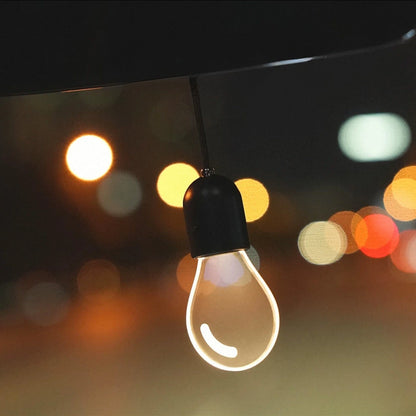 CARMOJ Glowing light bulb car charm showing warm white light