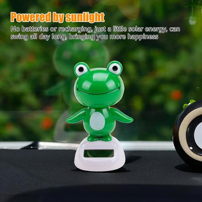 CARMOJ Solar-powered frog car ornament installed on a car dashboard