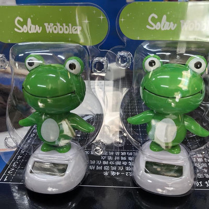 CARMOJ Solar-powered frog car ornament in retail packaging