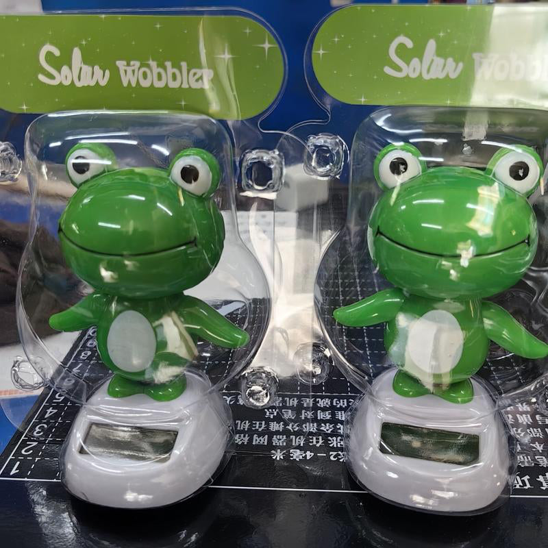 CARMOJ Solar-powered frog car ornament in retail packaging