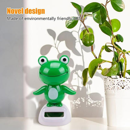 CARMOJ Solar-powered frog car ornament displayed near a sunny window